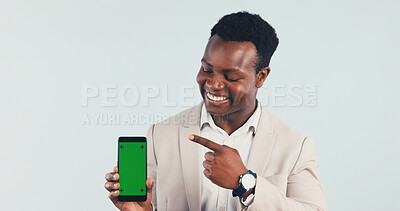 Buy stock photo Businessman, phone or pointing with green screen in studio for advertising on a white background. Black man, employee or showing smartphone display with smile for marketing mobile app on mockup space