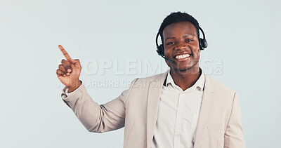 Buy stock photo Portrait, consultant and black man pointing in studio for online advice on a white background. Happy, businessman or agent with smile, headset or tips for virtual assistance, help or CRM on space