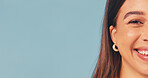Portrait, space and happy woman in studio for awareness campaign on a blue background. Half face, female person or smile with positive attitude for health, wellness or charity donation on mockup