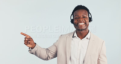 Buy stock photo Portrait, consultant or black man pointing in studio with headset for CRM advice on a white background. Male person, happy agent or customer service with smile for virtual assistance or help on space