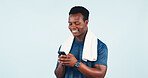 Fitness, phone and towel with black man in studio for health tracking or progress report. App, smile and space with happy person on white background for exercise feedback, text message or typing