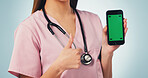 Nurse, hands and thumbs up with phone green screen for advertising on a blue studio background. Female person, healthcare worker or smartphone display with like emoji for UI, UX or Telehealth app