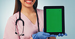 Nurse, hands and happy woman with tablet green screen for advertising on a blue studio background. Female person, healthcare worker or smile with technology display for UI, UX or Telehealth app