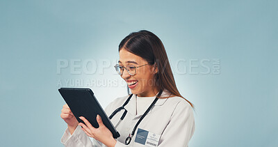 Buy stock photo Doctor, woman and laugh in studio with tablet, medical research and funny online review on website. Space, healthcare worker or happy person with tech, internet meme or telehealth on blue background.