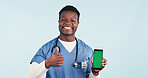 Nurse, portrait or black man with phone green screen for advertising on a blue studio background. Male person, healthcare worker or thumbs up with smile or smartphone display for UI, UX or app review
