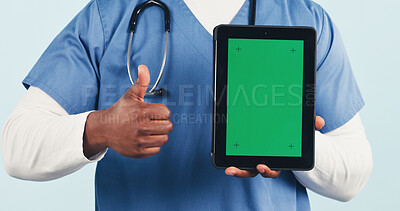 Buy stock photo Nurse, tablet and thumbs up with green screen for advertising on a studio background. Person, healthcare worker or technology display with like emoji or yes sign for UI, UX or app on mockup space