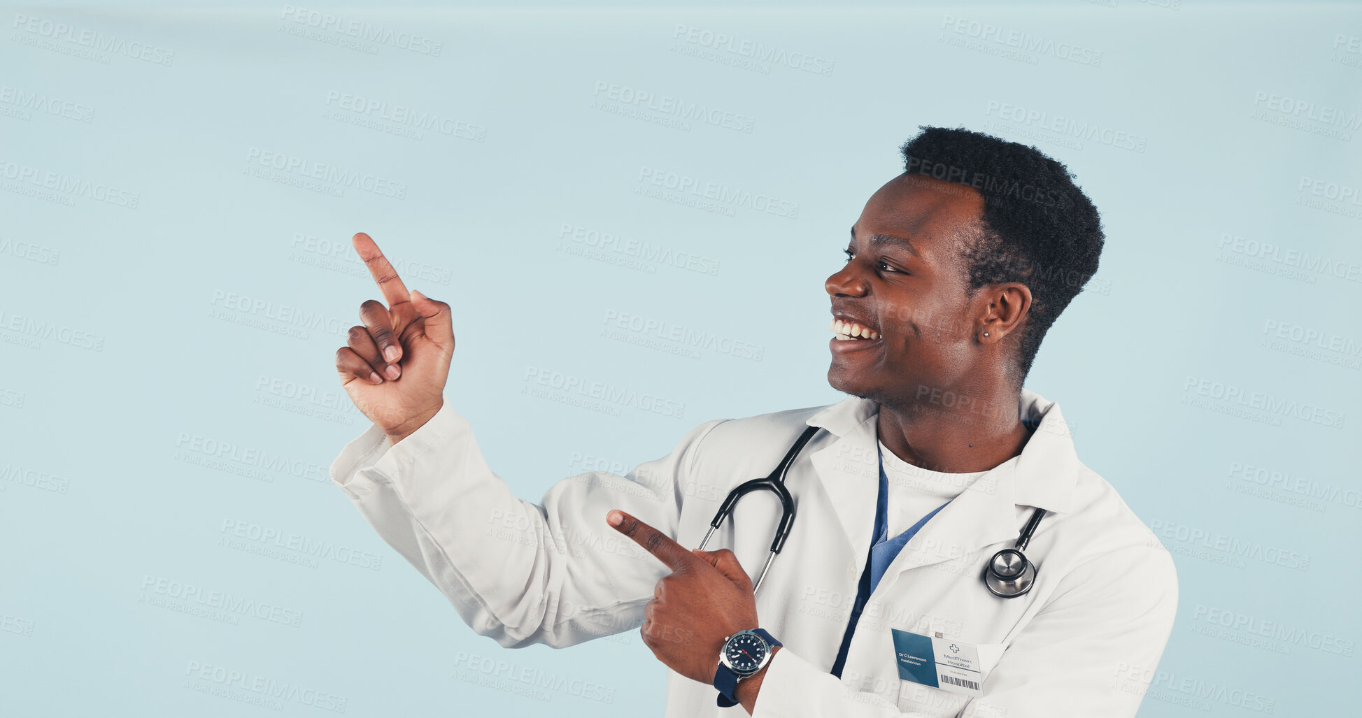 Buy stock photo Black man, doctor and pointing in studio with smile, advertising and sign up for medical advice. Space, person and hand gesture for presentation, coming soon and healthcare service on blue background