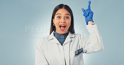 Buy stock photo Idea, science and surprise with portrait of woman in studio for healthcare solution, eureka or pointing. Medical breakthrough, research and problem solving with person on blue background with space