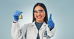Science, liquid and portrait of woman with thumbs up for success, chemistry and vaccine approval. Pharmaceutical, happy and person with sample, medical research and breakthrough on studio background