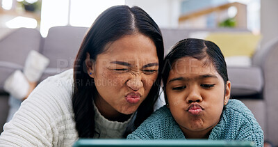 Buy stock photo Daughter, mother and selfie with tablet in living room of home for bonding or memories. App, funny face and picture of pouting girl child with single parent woman in apartment for family humor