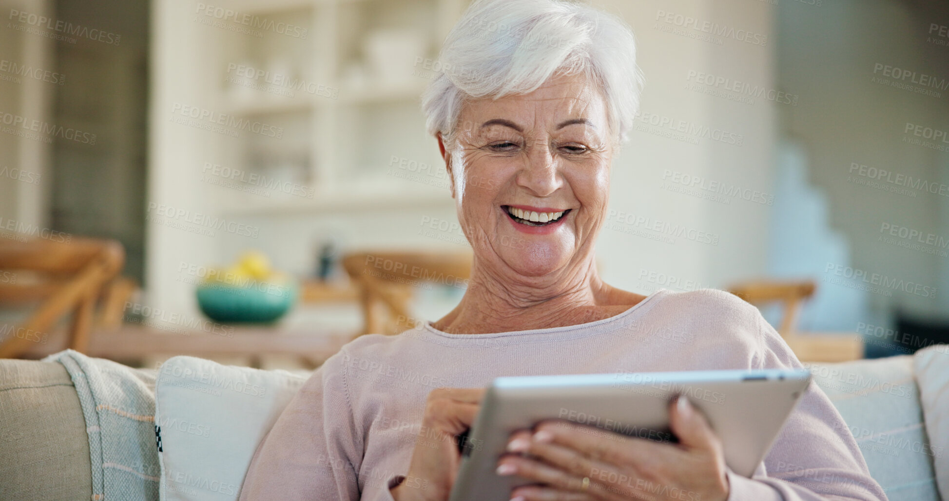 Buy stock photo Tablet, laugh and senior woman in home on website for ebook, online meme and funny story. Tech, retirement and person with digital literature on sofa at apartment for humor, entertainment or joke