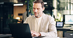 Business, man and reading in office with laptop, research and data analysis for company revenue. Mature person, typing and graphs in workplace with pc, audit report and information for finance profit