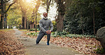 Fitness, start or old man in park with stretch, leg mobility or injury prevention in retirement activity. Wellness, knee or black person with preparing, senior hobby or muscle improvement in warm up.