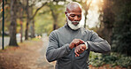 Fitness, man and scroll on smart watch at park for runner distance, heart rate and cardio speed. Earphones, mature black person and check timer for exercise, results and step counter on wellness app