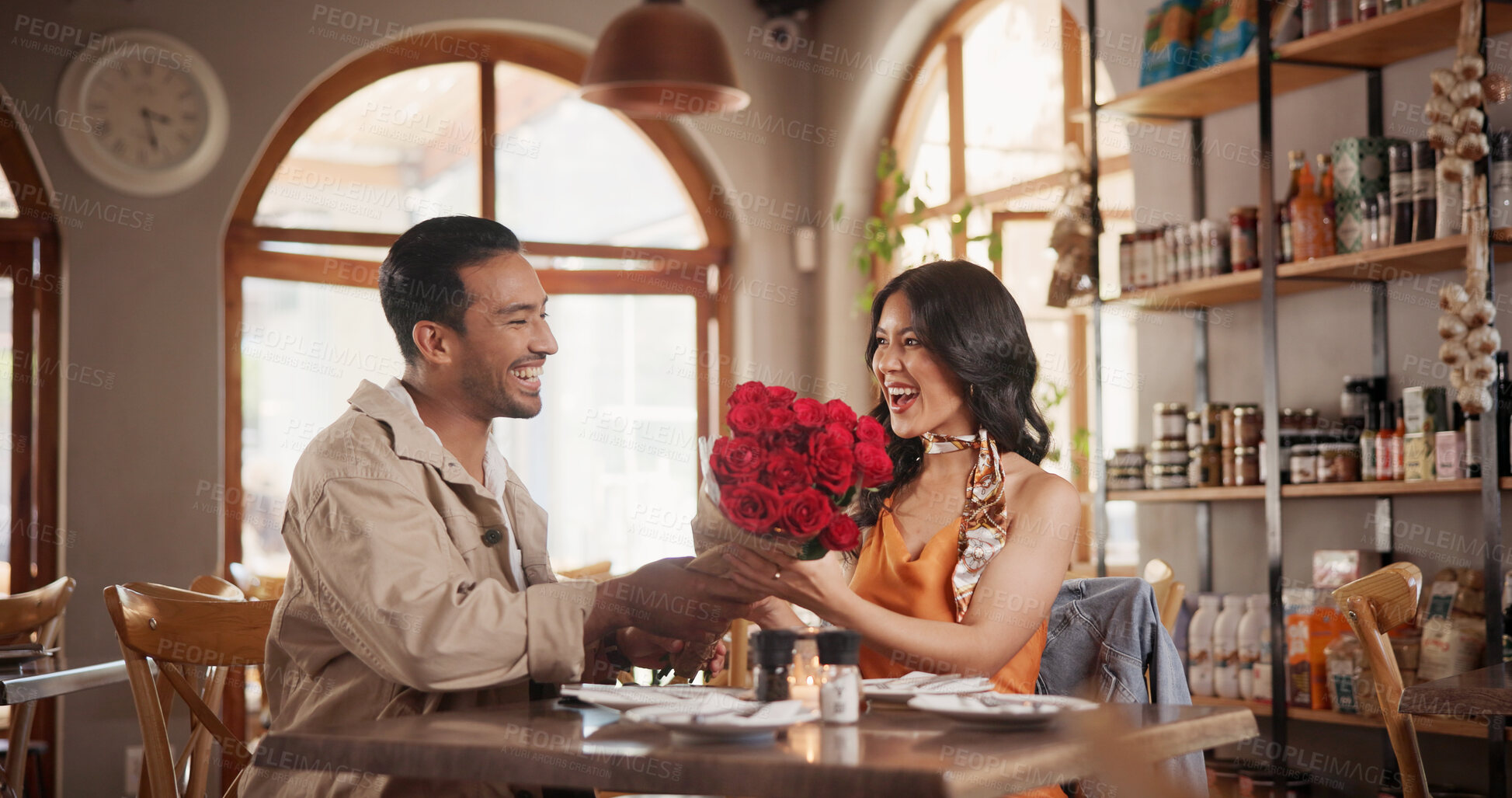 Buy stock photo Couple, surprise and roses in restaurant, date and relationship commitment with present and romance. Anniversary, celebration and happy for flower bouquet, shocked woman and bonding with man in diner