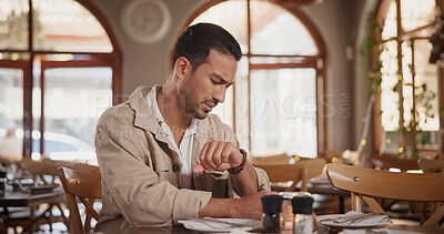 Buy stock photo Late, reservation and man in restaurant with watch, impatient and waiting for first date. Worry, stress and person in cafe with clock check, uncertainty and bad time management for romantic outing.