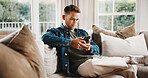 Phone, relax and man on sofa in home with texting, chatting or social media on mobile app. Research, chilling and person on cellphone for reading online blog for advice in living room at house.