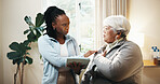 Old woman, shoulder pain and physiotherapist with tablet in home for concern, feedback or review. App, check and chiropractor with senior patient in apartment for healing, injury or rehabilitation