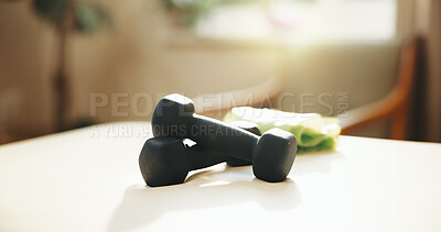 Buy stock photo Fitness, dumbbells and equipment on table for exercise, wellness or development in empty room. Workout gear, home or weight set for bodybuilding, resistance training or practice for health with towel