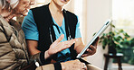 Hands, tablet and old woman with nurse for conversation, support or consultation in nursing home. Homecare, senior person and caregiver with healthcare, feedback and checkup review in living room