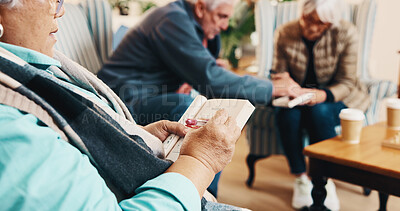 Buy stock photo Hands, old woman and reading at house with crossword, word search and quiz for health. Senior person, writing and book in home with sudoku games, problem solving and puzzle activity for brain teaser