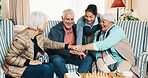Happy, senior or hands together with caregiver for unity, healthcare or support in retirement home. Group, nurse or piling with smile or stack in old age house for elderly care, inclusion or cohesion