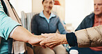 Senior, group and holding hands with caregiver for social support or praying together in house. Elderly, people and therapy session with patients in circle or retirement home for faith, trust or love