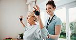 Happy, dumbbells and senior woman for physiotherapy, rehabilitation and mobility for arthritis. Healthcare, physical therapist and patient with weights for exercise, arm support and muscle strength