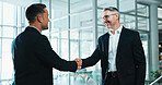 Businessmen, meeting and handshake in office for deal, introduction or business agreement together. Male people, employees or colleagues shaking hands with smile for b2b or partnership in workplace