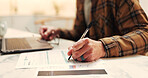 Finance, hands and writing on form in home for homeowner insurance, personal info or legal agreement. Laptop, man or filling papers at table for mortgage protection, house registration and compliance