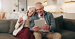 Happy, old couple and coffee in home with tablet, good news and announcement for lottery winner. Smile, senior people and beverage at house with digital, notification email and giveaway prize on sofa