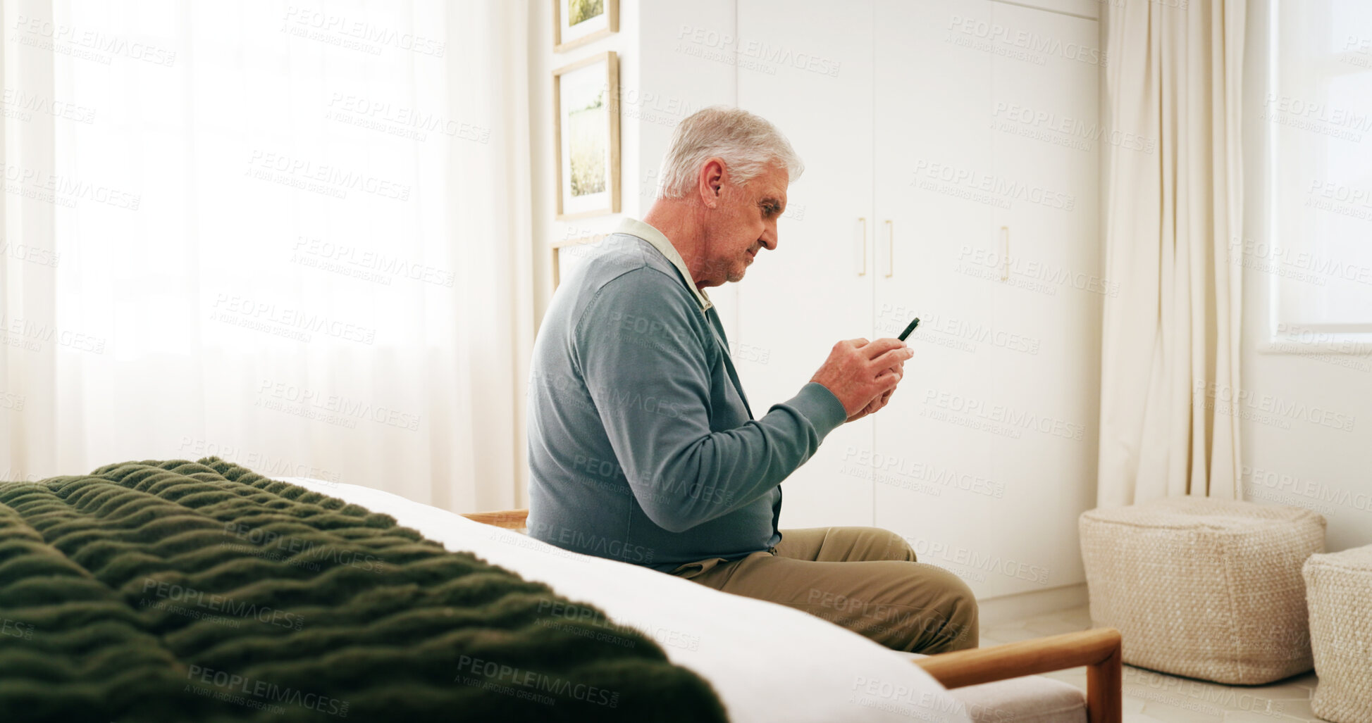 Buy stock photo Bedroom, chat and senior man with phone, serious and communication with contact on social media app. Reading, message and person with mobile on chair, retirement and networking on website in house