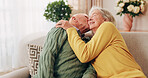 Love, kiss and senior couple in home for care, relationship security and loyalty with happy partner. Man, woman and romance on sofa with smile, commitment and connection together in retirement