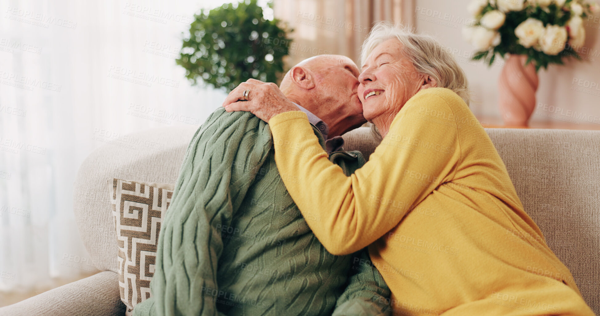 Buy stock photo Love, kiss and senior couple in home for care, relationship security and loyalty with happy partner. Man, woman and romance on sofa with smile, commitment and connection together in retirement