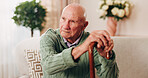 Cane, relax and thinking with old man on sofa in living room of home for retirement or wellness. Break, nostalgia and walking stick with senior in apartment for contemplation memories or reflection