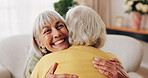 Friends, hug and support with old women in home for bonding, good news or retirement. Happiness, love and social reunion with senior people in living room for embrace, smile and care in house