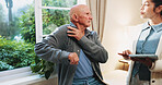 Healthcare, shoulder pain and tablet with senior man in physio clinic for checkup or feedback. App, conversation and old person in rehabilitation center with chiropractor for consulting or diagnosis