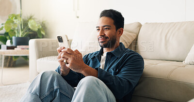 Buy stock photo Message, connection and man in home with phone, online chat and post reaction on social media app. Reading, happy and person in house with tech, text notification or communication on digital platform