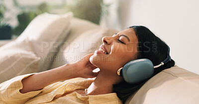 Buy stock photo Headphones, calm and woman on sofa in home for listening to music, playlist and album. Relax, audio tech and happy person streaming online radio, track or song for break in living room at house.