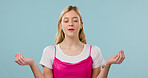 Woman, lotus and yoga in studio for meditation, holistic balance and spiritual healing for zen. Person, eyes closed and fitness for inner peace, practice mindfulness and self care on blue background