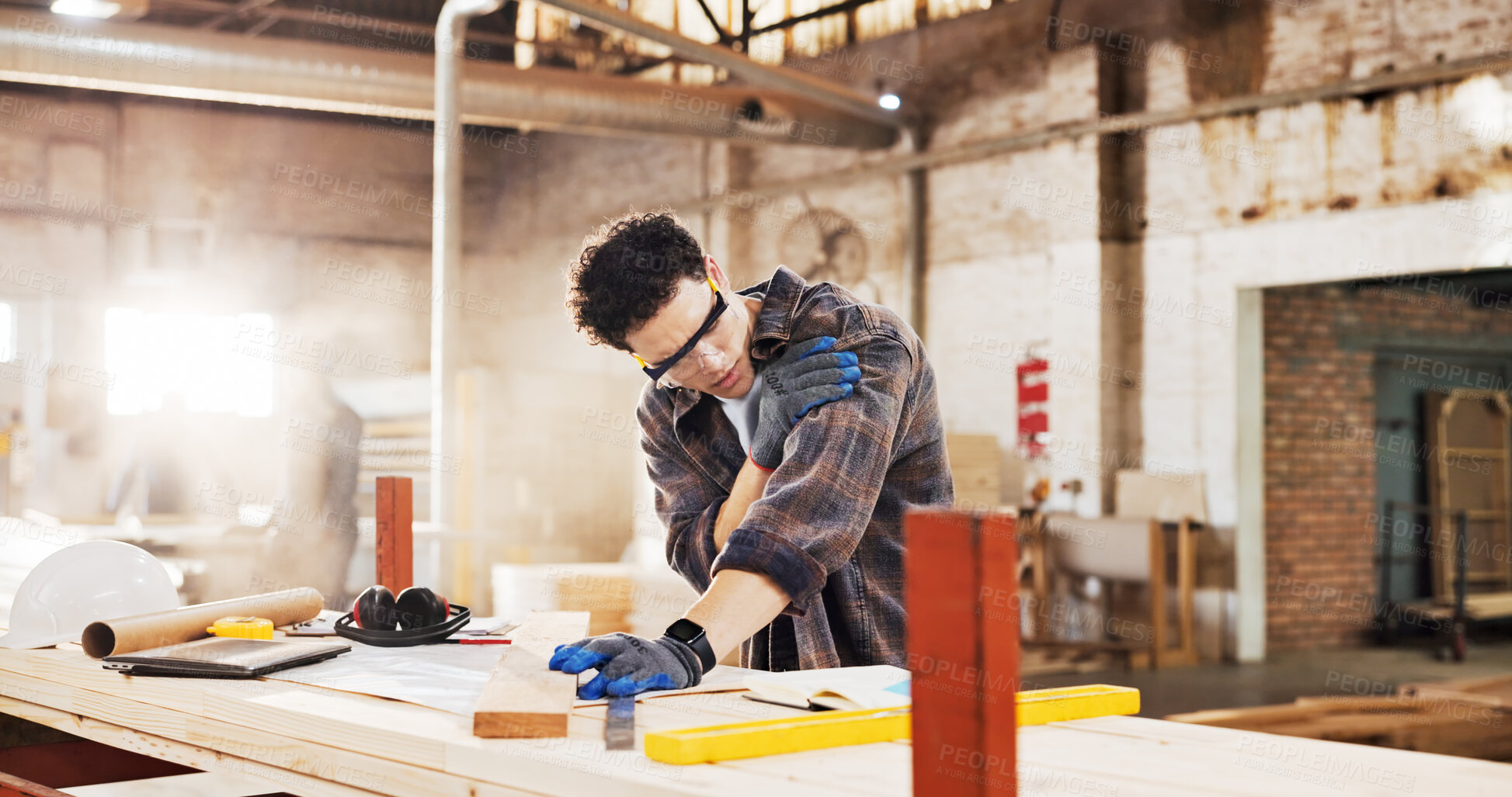 Buy stock photo Carpenter, injury and man in workshop with wood for manufacturing, shoulder pain and production. Person, hurt and warehouse with strain for custom or handmade woodworking, dislocation and timber