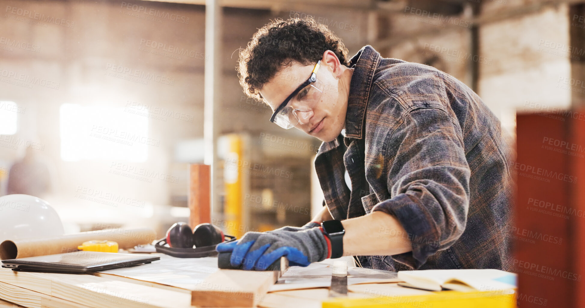 Buy stock photo Carpenter, sanding and man in warehouse with wood for manufacturing, productivity and production. Person, safety gear and workshop with tools for custom or handmade woodworking, workbench and timber