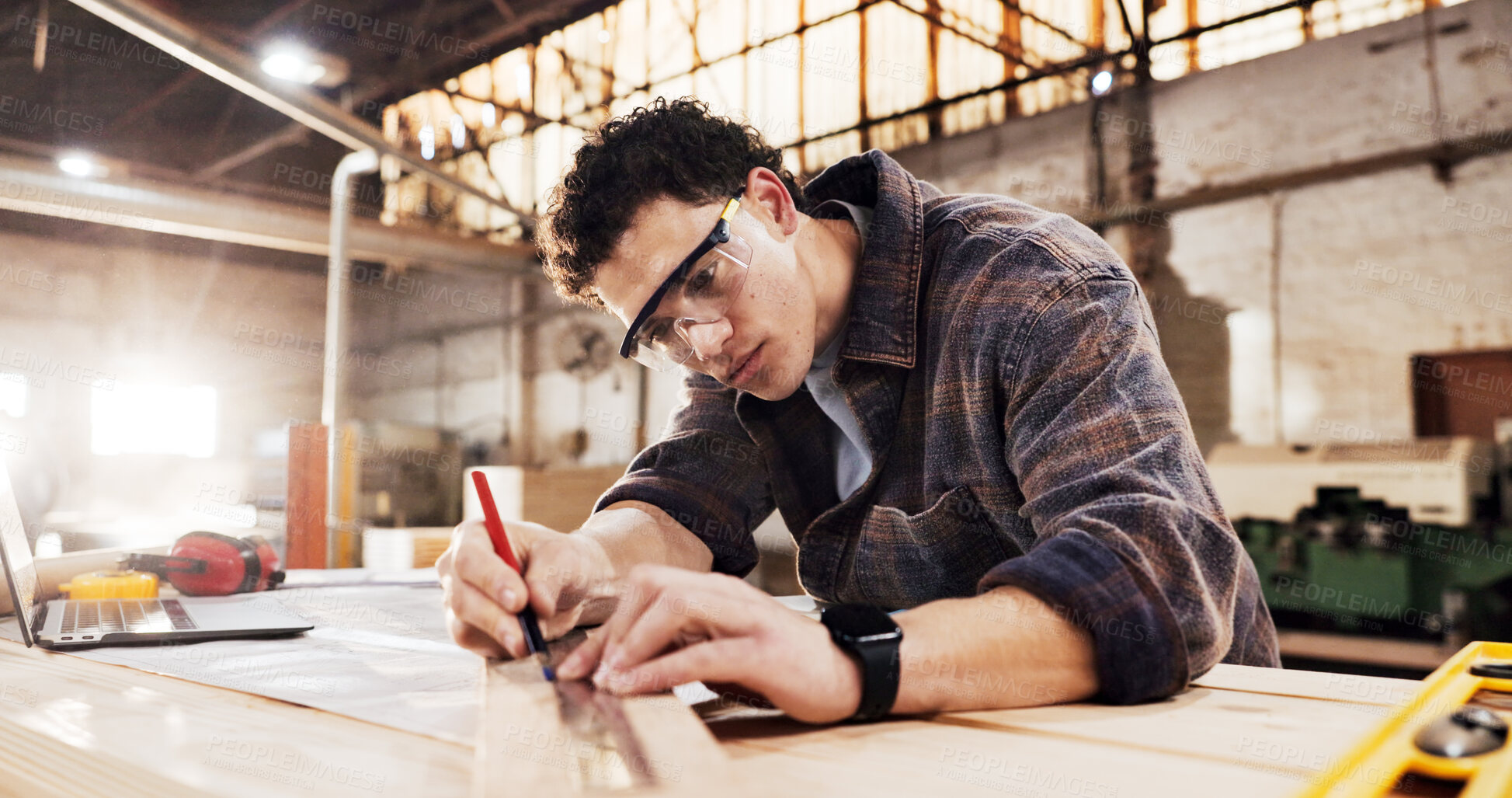 Buy stock photo Carpenter, measure and man in workshop with wood for manufacturing, productivity and production. Person, ruler and warehouse with pencil for custom or handmade woodworking, workbench and timber