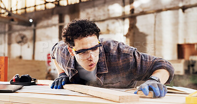 Buy stock photo Carpenter, sanding and man blow dust in workshop with wood for clean, productivity or production. Person, safety gear and warehouse with tools for custom or handmade woodworking, workbench and timber