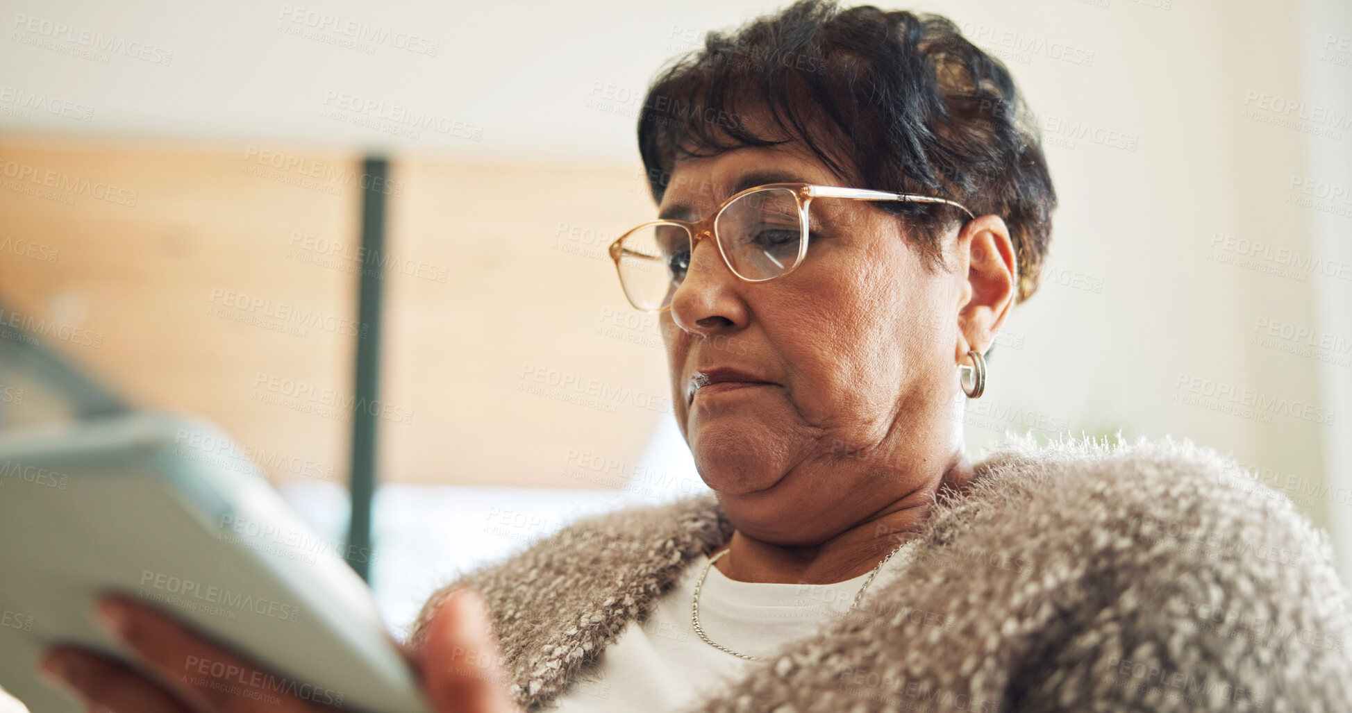 Buy stock photo Senior, woman and browsing in home with tablet, glasses and social media for entertainment on weekend. Pensioner, person and internet in living room with tech, online blog and relax for retirement.