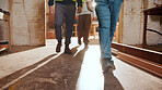 Legs, people and walking in workshop for carpentry, inspection and safety check for woodwork. Feet, team and inspector in warehouse for quality assurance, timber compliance and manufacturing industry