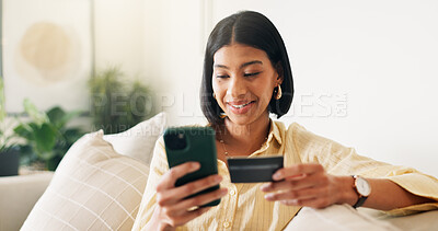 Buy stock photo Credit card, phone and woman on sofa for online shopping, digital purchase and internet banking. Happy, home and person on mobile app with debit info for ecommerce, subscription and web discount