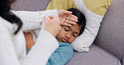 Buy stock photo Fever, forehead and hand of mother with daughter on sofa in home living room for childcare. Rest, temperature and thermometer with woman checking girl in apartment for healthcare and recovery