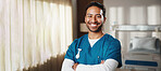 Crossed arms, man and portrait of nurse in hospital with confidence for career in medical support. Smile, professional and healthcare worker with pride for about us with service at clinic in Colombia