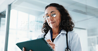 Buy stock photo Healthcare, doctor and woman with tablet in clinic for insurance report, reading or scroll email. Mature, medical professional and digital tech for results, review or research information in hospital